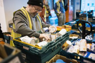 A volunteer for FareShare Northern Ireland sorts through food rescued from going to waste - it will then be redistributed to charities across the country